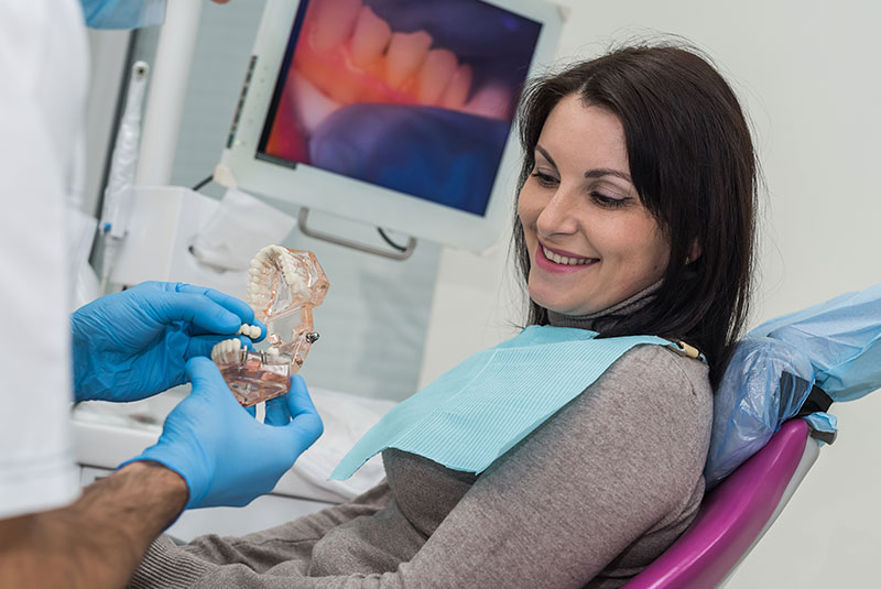 dr showing dental bridge