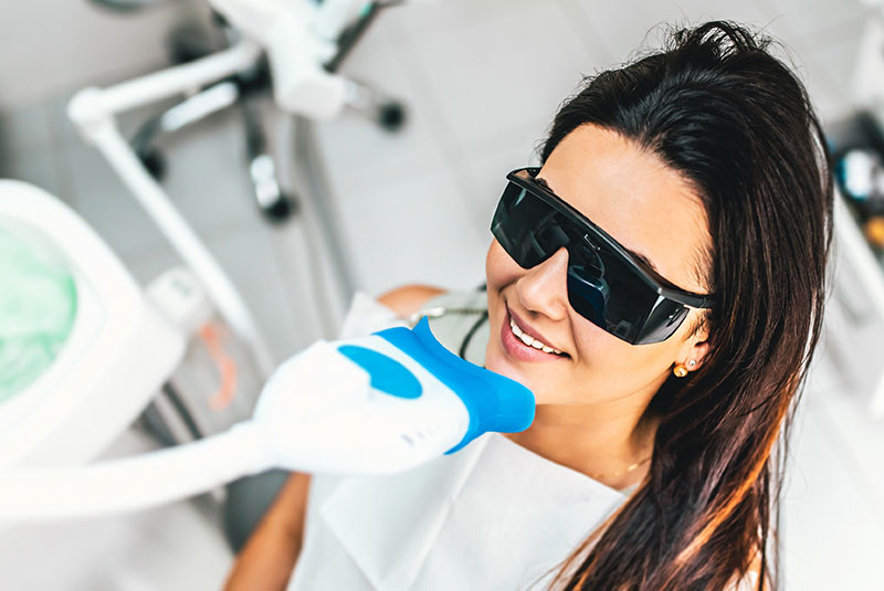 girl doing teeth whitening