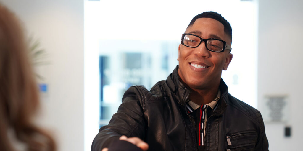 man with his new smile shaking hands