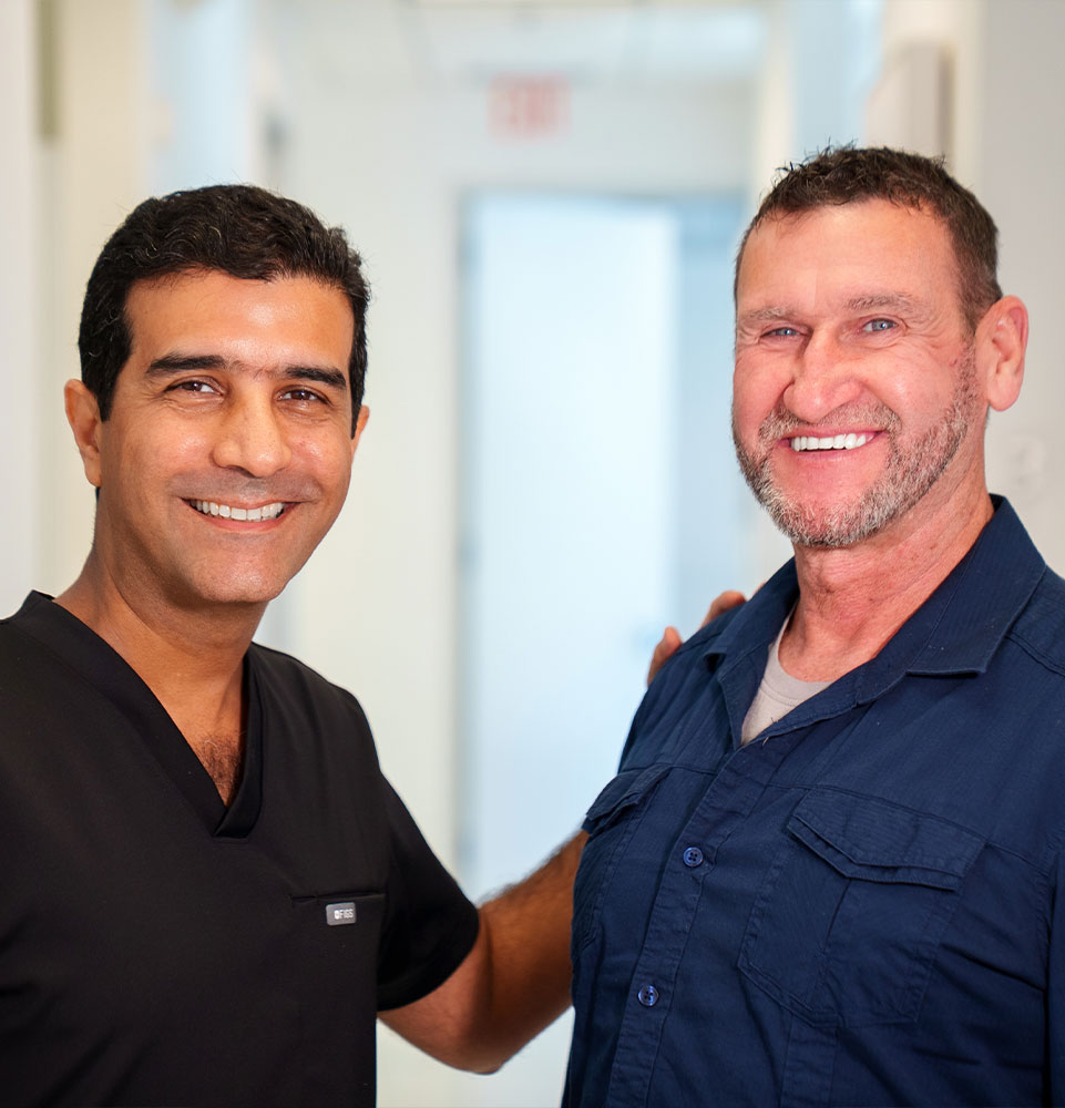 man with blue shirt smiling with doc