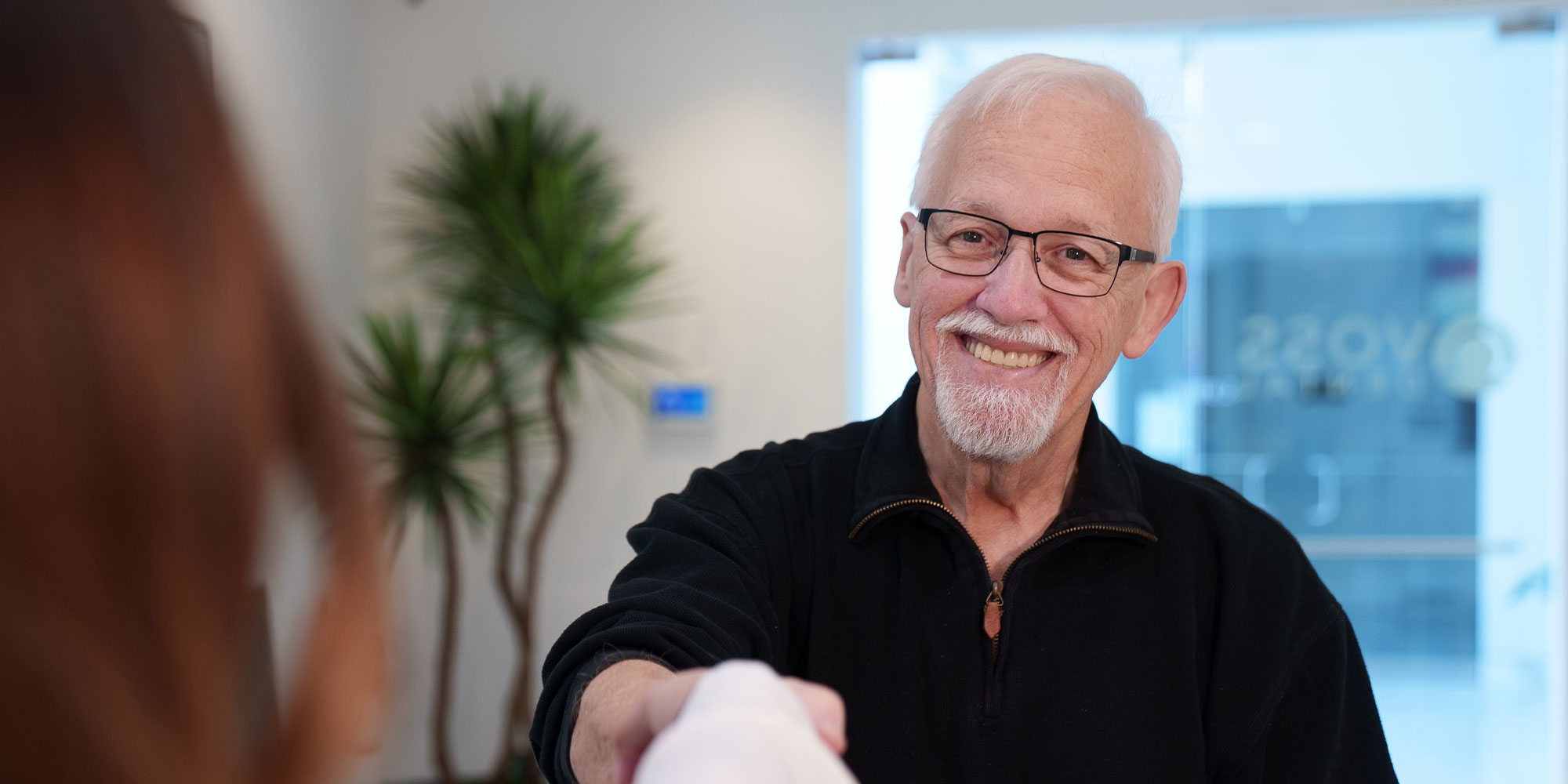man shaking ladies hand at front